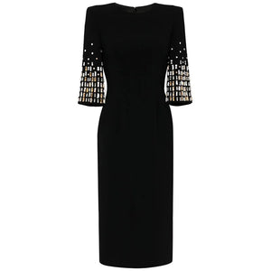 Black dress with embellished sleeves on a white background