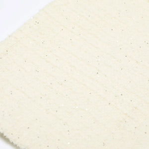 Close-up of a textured beige fabric with a subtle pattern on a white background