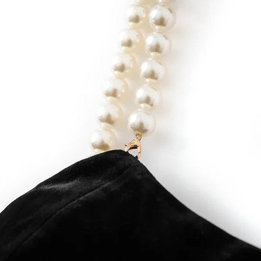 Pearl necklace on a mannequin head with a plain white background