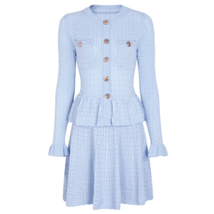 Light blue dress with button details on a white background