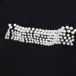 Pearl embellished design on a black background