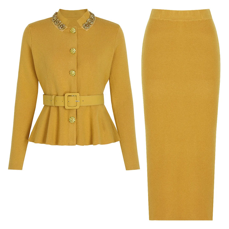Mustard yellow jacket and skirt set with decorative buttons on a white background