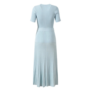 Light blue ribbed dress with pleated skirt on a white background
