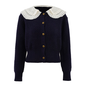 Navy blue cardigan with white lace collar on a white background