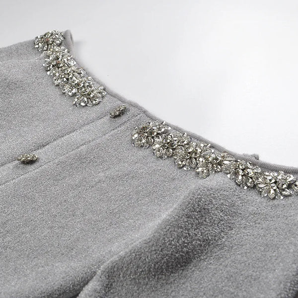 Gray garment with decorative embellishments on a white background
