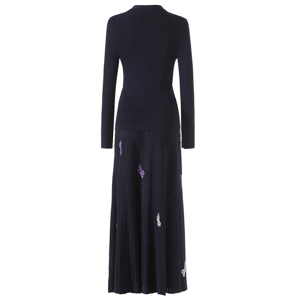 Black dress with floral embellishments on a white background