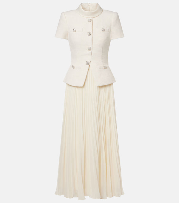 An off-white two-piece set featuring a short-sleeve cropped jacket with decorative silver-tone buttons and a matching pleated maxi skirt, shown against a plain light gray background.