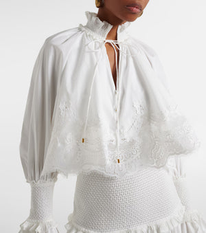 White lace top with ruffled sleeves on a white background