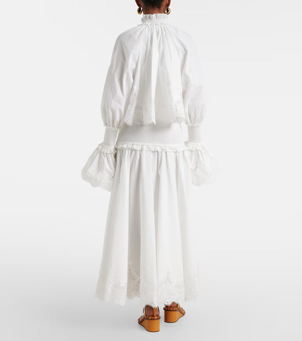 White outfit with long sleeves and a skirt on a white background