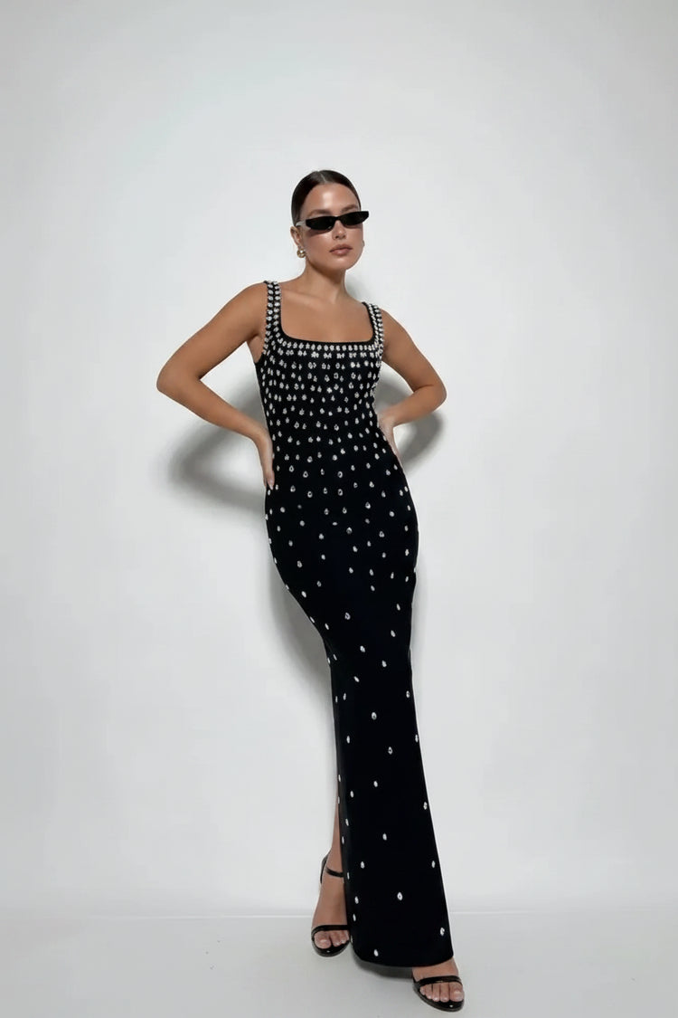 Woman wearing a black dress with white patterns on a white background