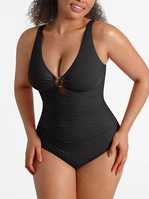 Woman wearing a black swimsuit with a plain background