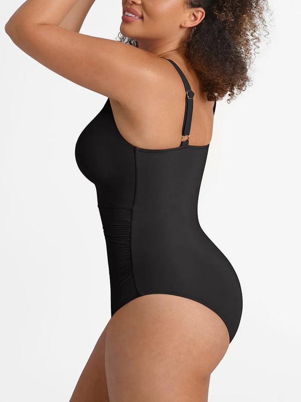Black swimsuit worn by a model on a white background