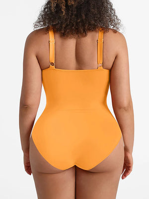 Person wearing a mustard yellow swimsuit on a plain background
