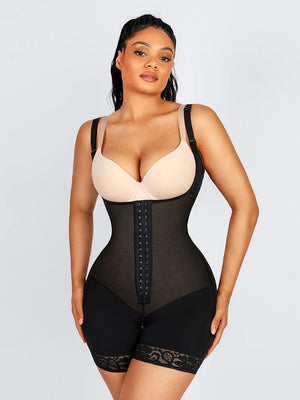 Woman wearing a black waist trainer against a light gray background