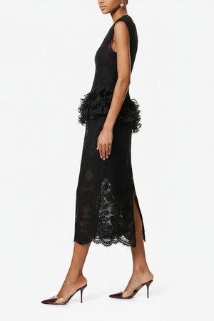 Black lace dress with ruffled details on a white background