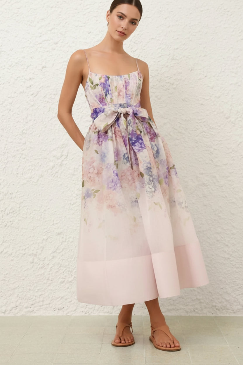 Woman wearing a floral dress with a white textured wall background