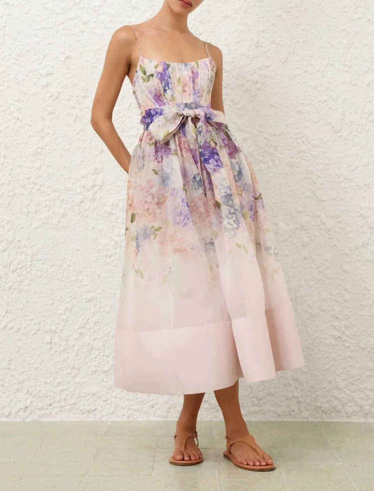 Woman wearing a floral dress with a white textured wall background